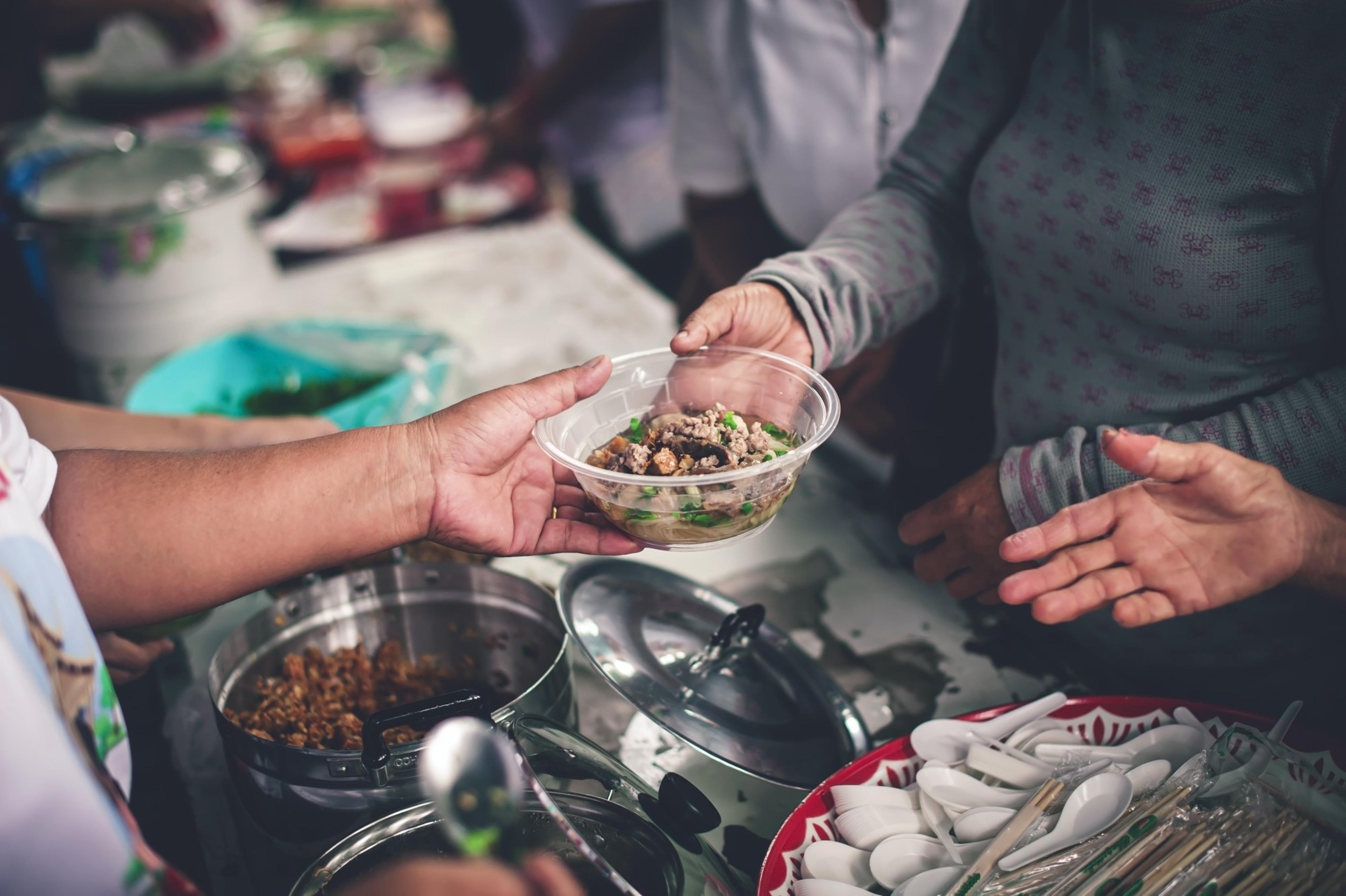 Peoples serve food to each other